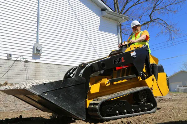 Mini skid steer loader used in Utility Work