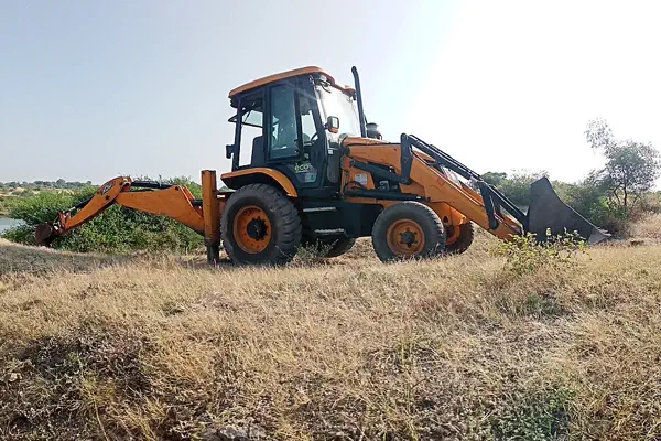 backhoe loader used in agrivultural field